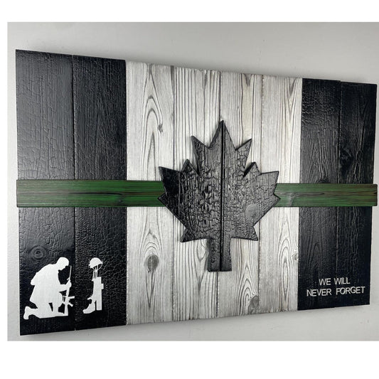 A handcrafted Canadian military flag made using the Shou Sugi Ban technique, giving the wood a rich, charred finish. The flag features a green thin line running horizontally across the design, symbolizing support for the military. The maple leaf emblem stands out against the dark, burned wood, highlighting the craftsmanship and depth of the texture.
