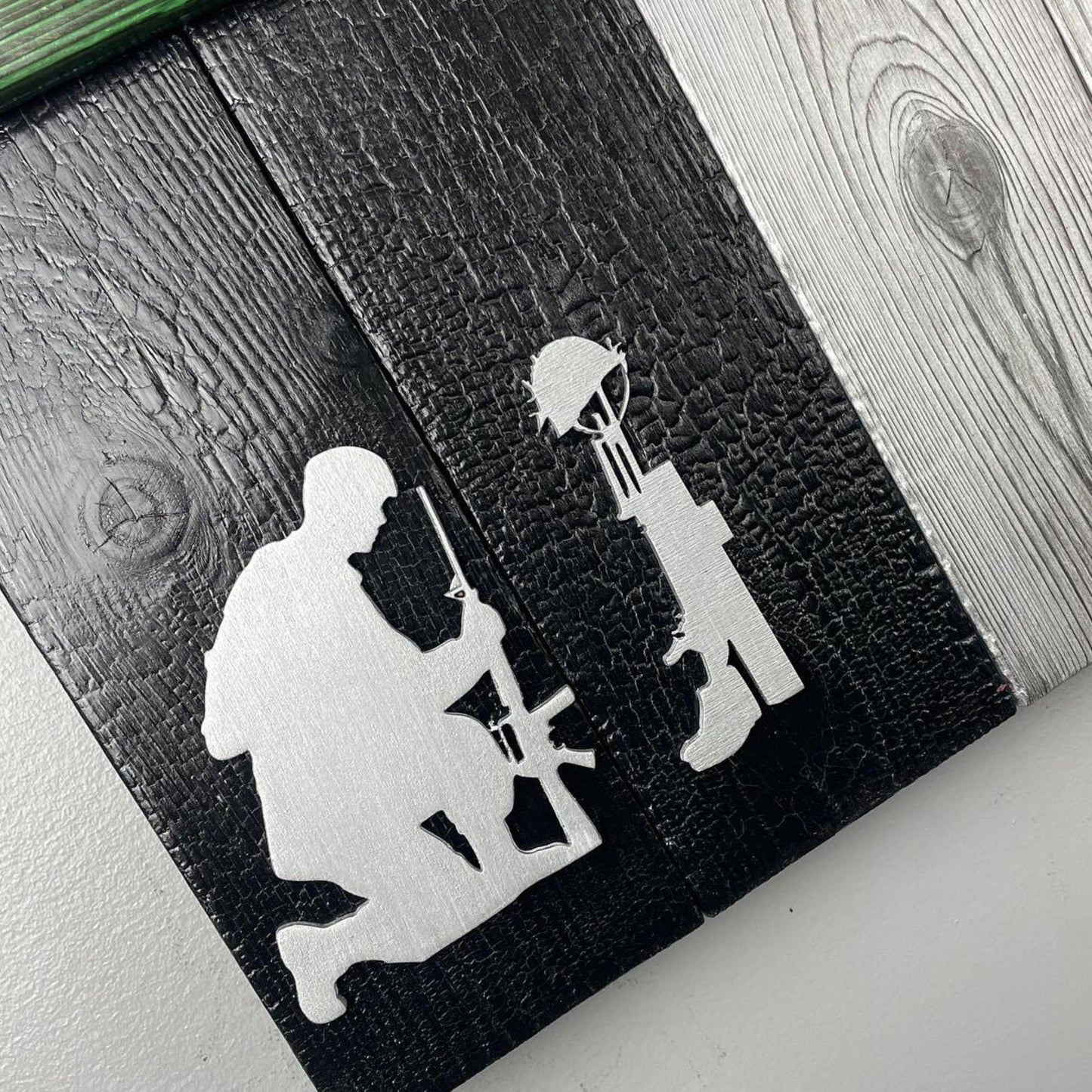 A handcrafted Canadian military flag made using the Shou Sugi Ban technique, giving the wood a rich, charred finish. The flag features a green thin line running horizontally across the design, symbolizing support for the military. The maple leaf emblem stands out against the dark, burned wood, highlighting the craftsmanship and depth of the texture.